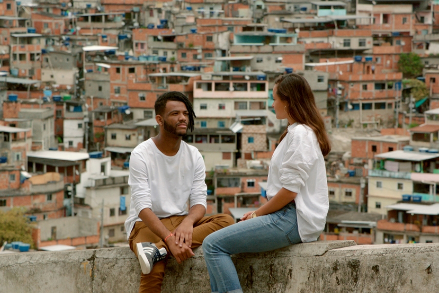 Homme discutant avec une femme au sommet d'une ville avec énormément de batiments.