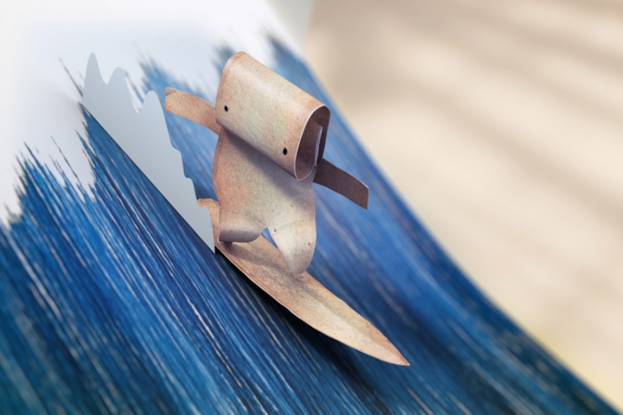Un personnage en papier fait du surf sur une vague en papier.