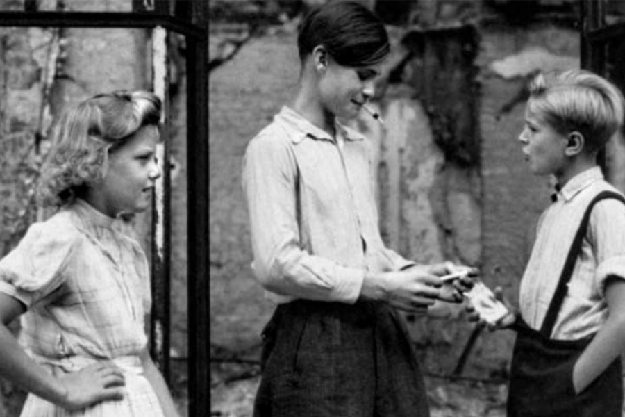 Photo en noir et blanc, trois enfants sont ensemble.