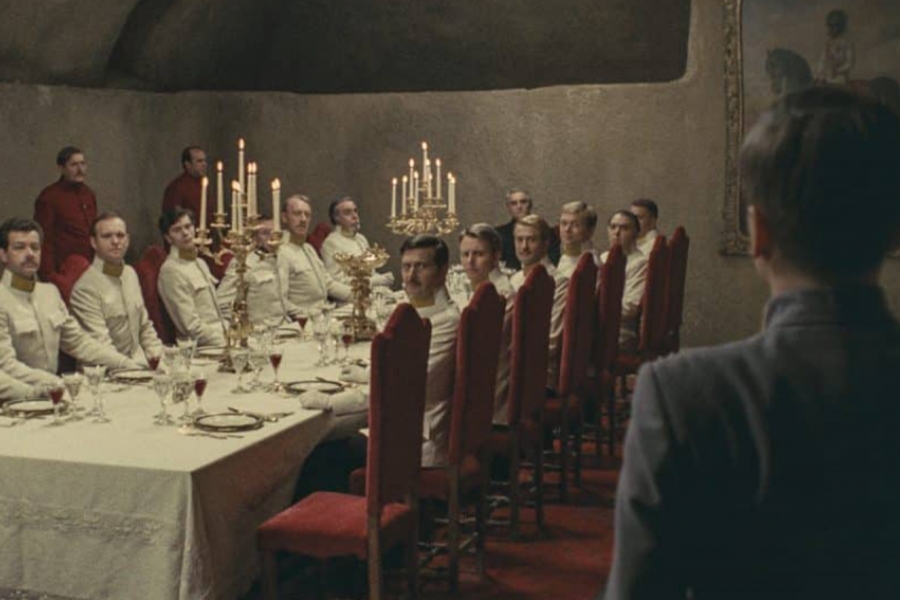 Un groupe d'hommes a table, un autre au premier plan arrive