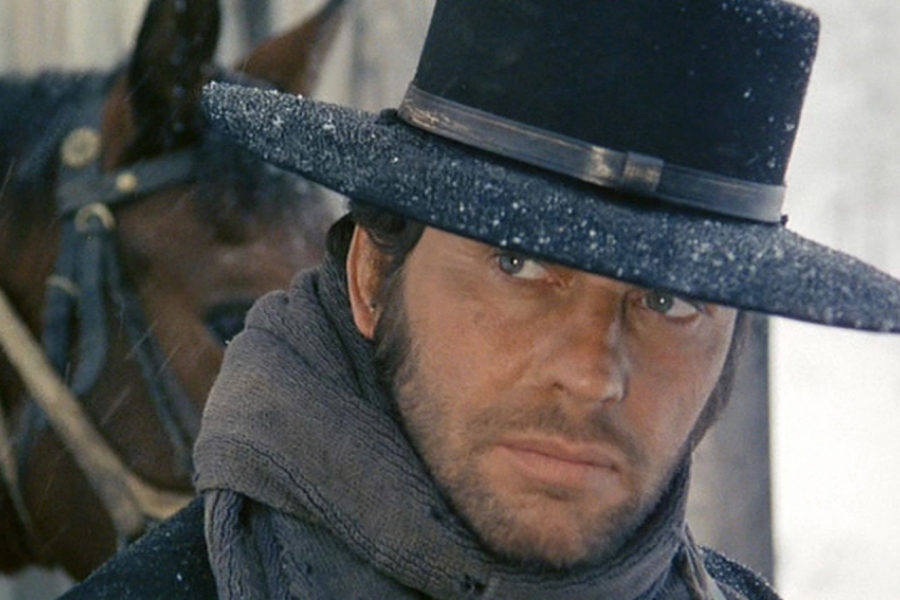 Un homme sous la neige avec son cheval 